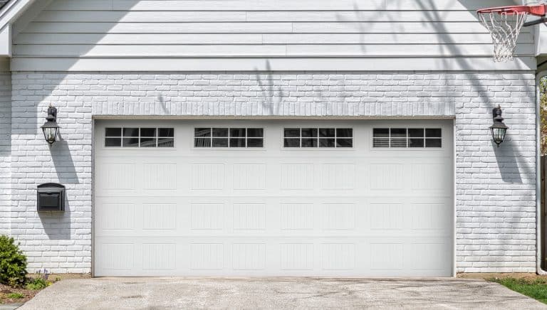 Ameripro Garage Doors white garage doors before new doors at a home in North Florida | Ameripro Garage Doors serves Bay County, Walton County and the surrounding Florida cities with garage door installations, garage door repairs, and garage door maintenance for homes and businesses.